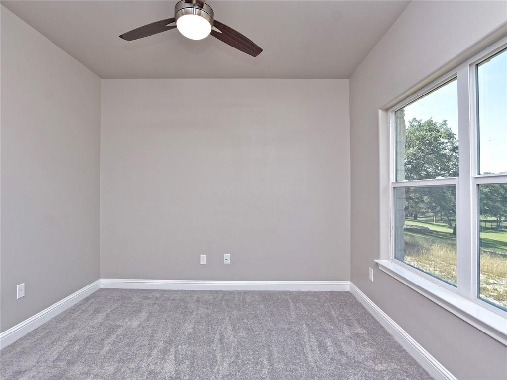 133 Tuscany Way Georgetown, TX 78633 - Photo 29 of 30 wooden floor in an empty room with a window