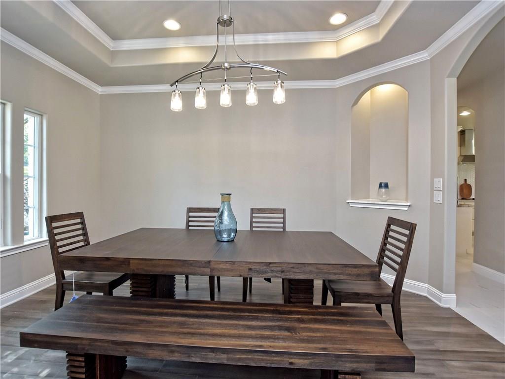 133 Tuscany Way Georgetown, TX 78633 - Photo 6 of 30 a view of a dining room with furniture and wooden floor