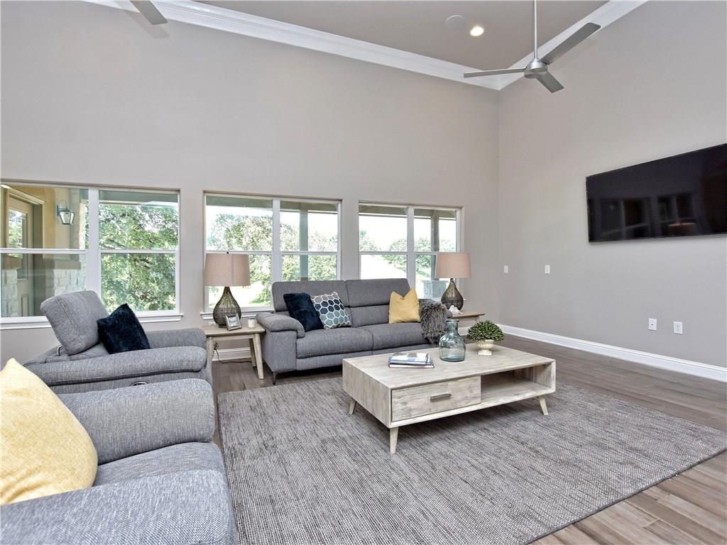 133 Tuscany Way Georgetown, TX 78633 - Photo 7 of 30 a living room with furniture and a flat screen tv