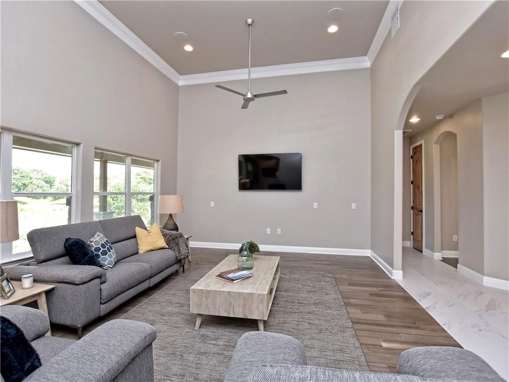 133 Tuscany Way Georgetown, TX 78633 - Photo 8 of 30 a living room with furniture wooden floor and a flat screen tv