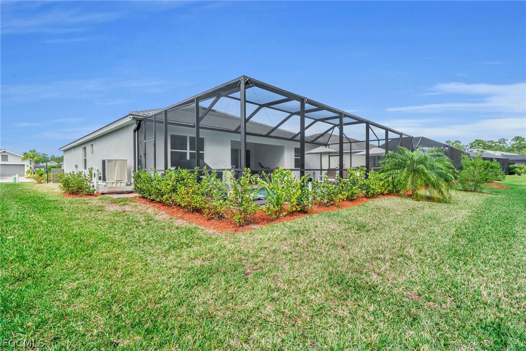 17388 Walnut Run Drive Alva, FL 33920 - Photo 24 of 24 a front view of a house with a yard and potted plants