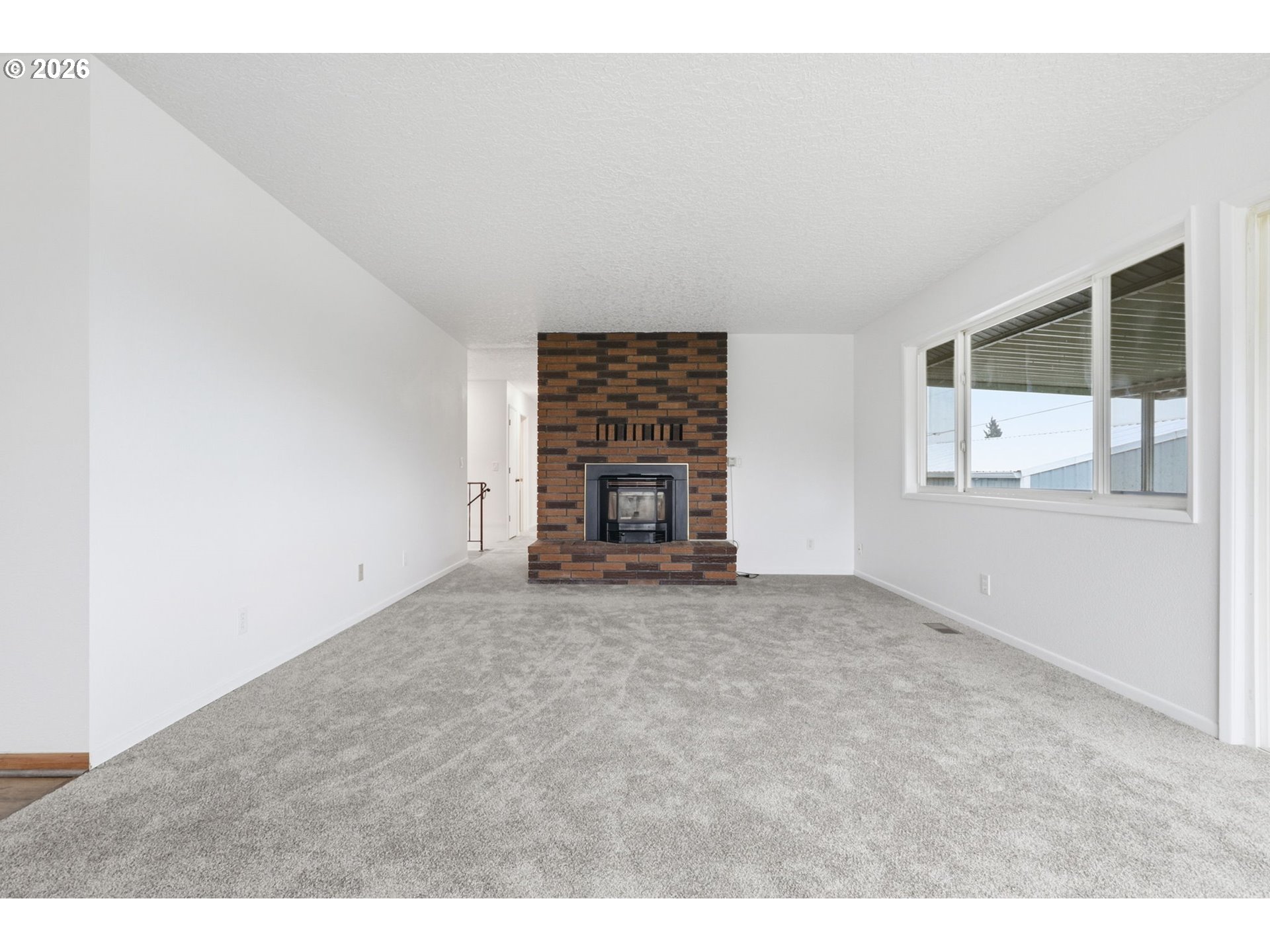 52890 Northwest 7th Street Scappoose, OR 97056 - Photo 14 of 48 a view of an empty room with a fireplace