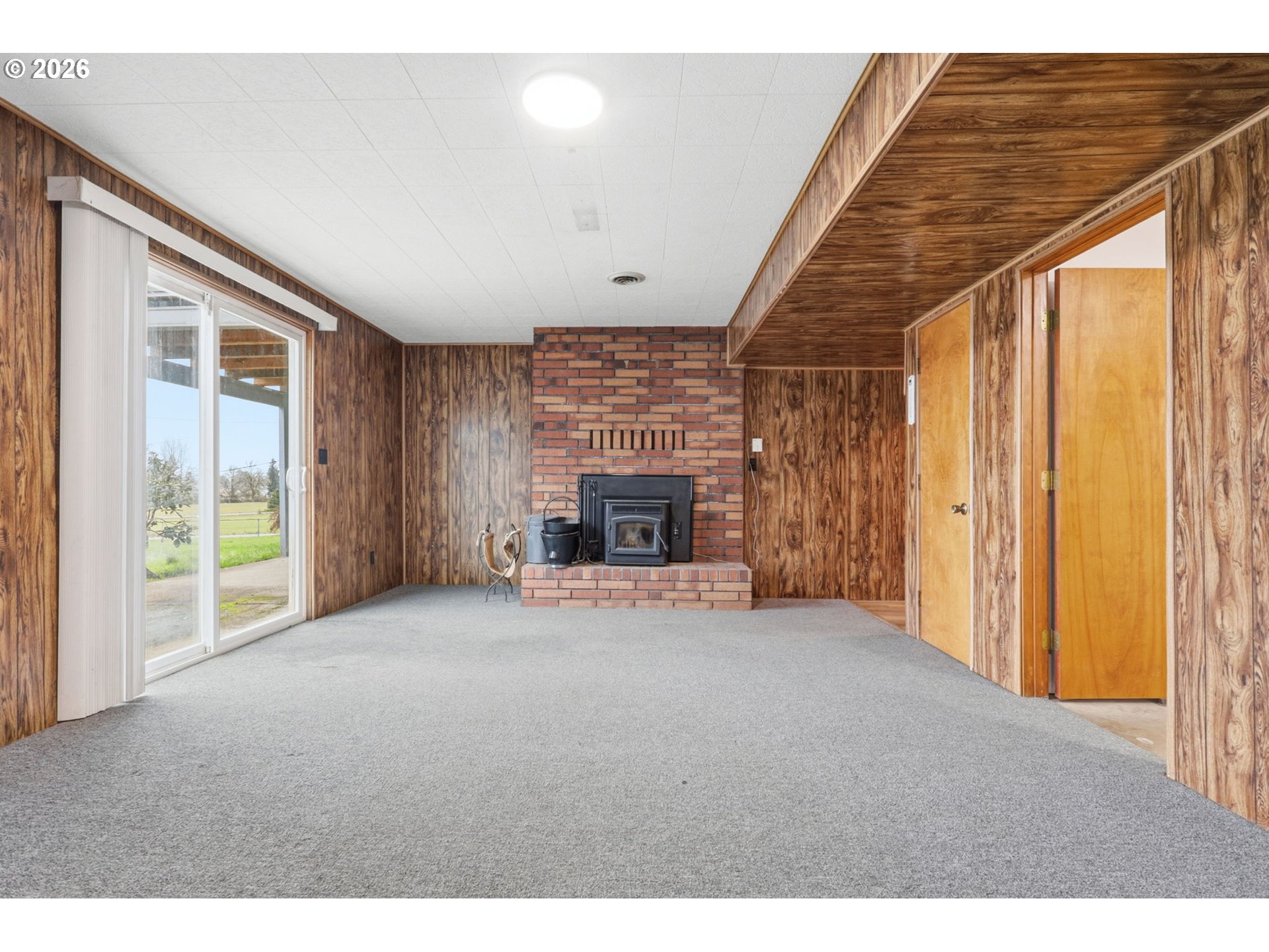 52890 Northwest 7th Street Scappoose, OR 97056 - Photo 27 of 48 a view of an empty room with a fireplace and a window