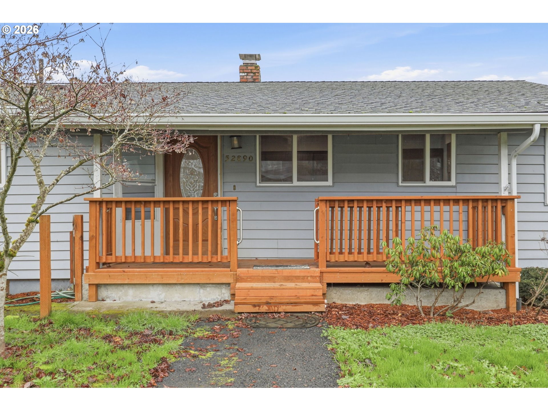 52890 Northwest 7th Street Scappoose, OR 97056 - Photo 4 of 48 a front view of a house with a yard