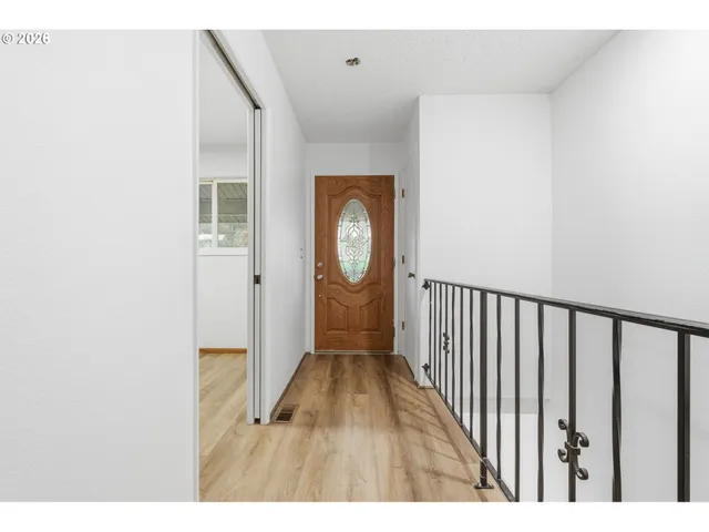a view of a hallway with wooden floor