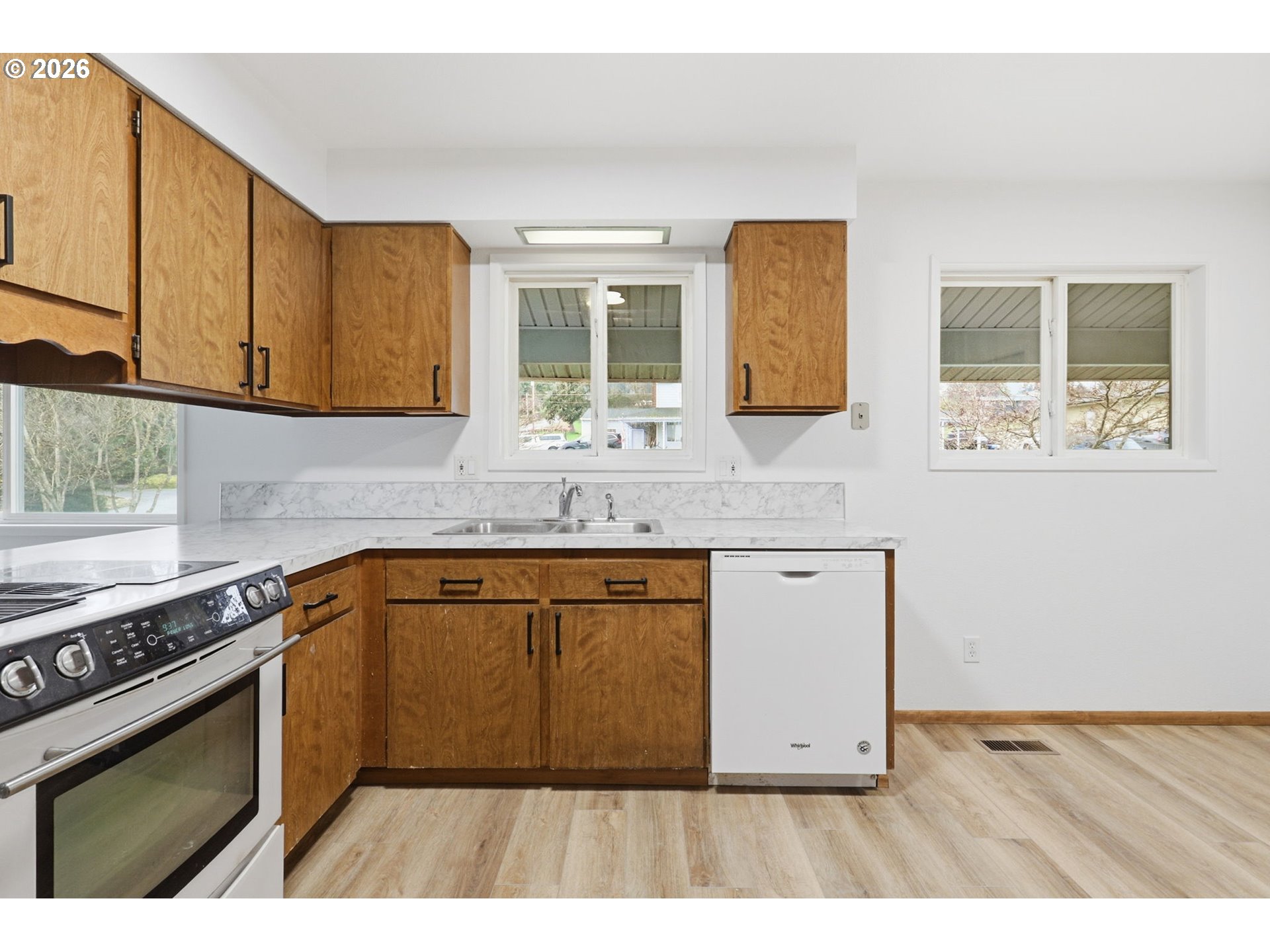 52890 Northwest 7th Street Scappoose, OR 97056 - Photo 9 of 48 a kitchen with stainless steel appliances granite countertop a stove a sink and a microwave