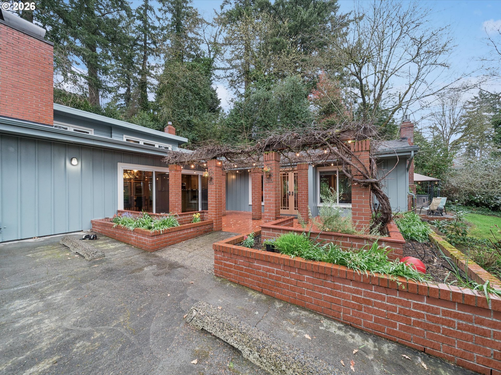 8401 Southwest Canyon Lane Portland, OR 97225 - Photo 2 of 48 front view of house with a yard and potted plants
