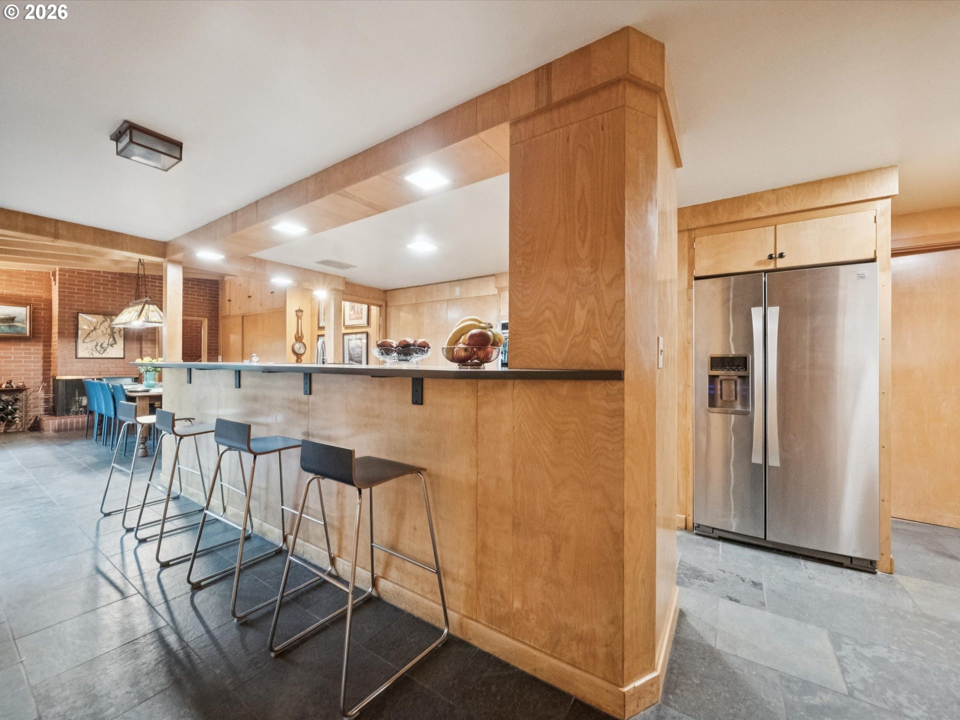 8401 Southwest Canyon Lane Portland, OR 97225 - Photo 25 of 48 a kitchen with stainless steel appliances granite countertop a refrigerator and a dining table