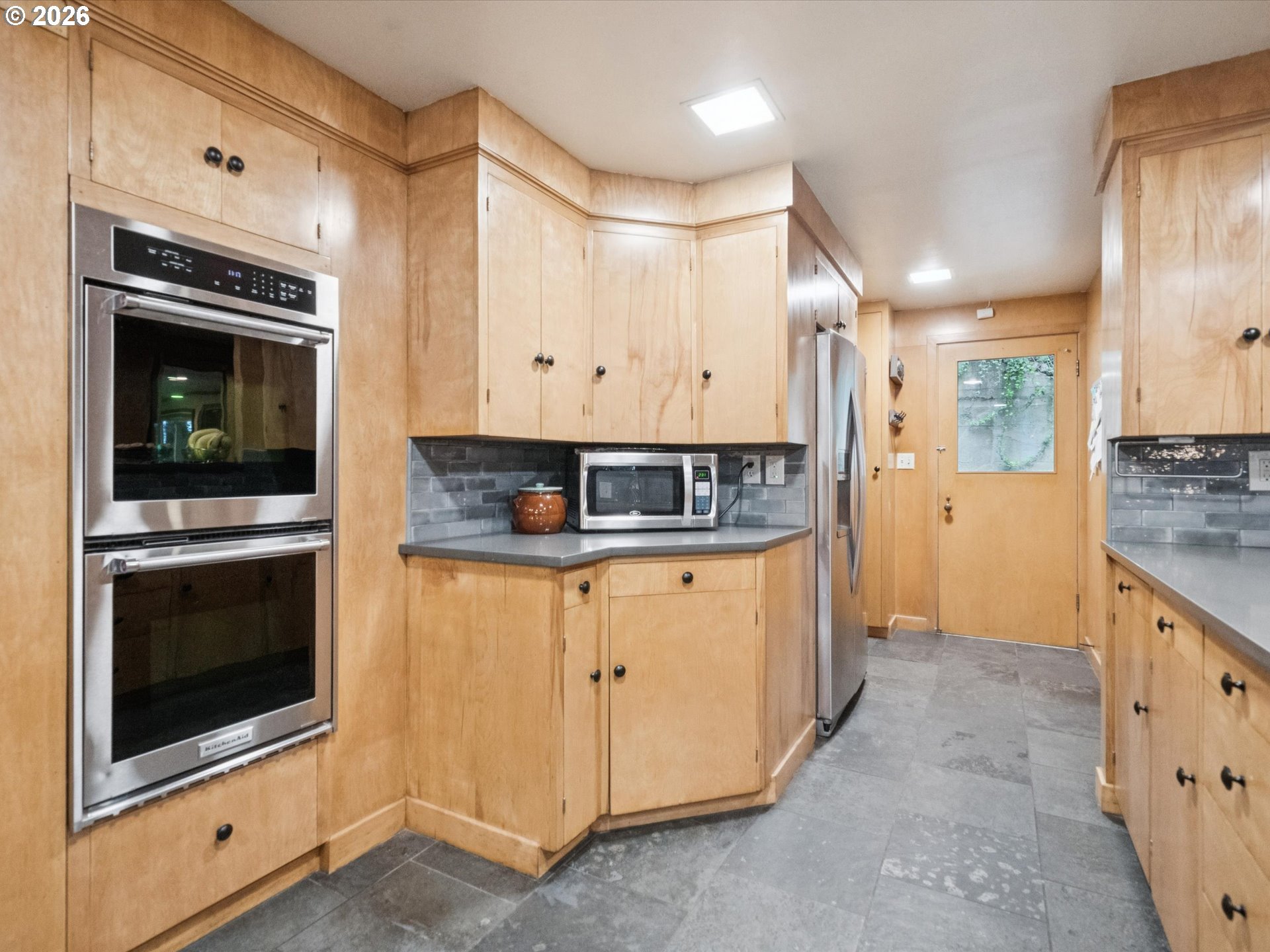 8401 Southwest Canyon Lane Portland, OR 97225 - Photo 26 of 48 a kitchen with stainless steel appliances granite countertop a stove a microwave and a refrigerator