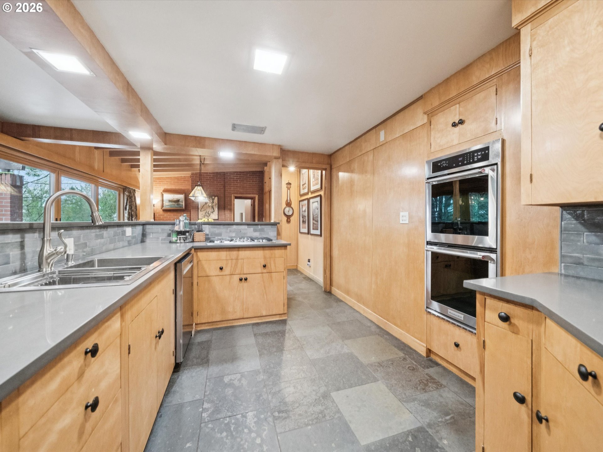 8401 Southwest Canyon Lane Portland, OR 97225 - Photo 4 of 48 a large white kitchen with a large window