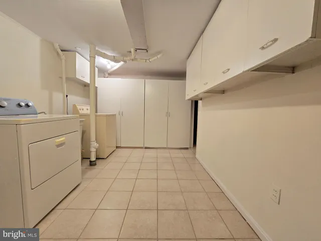 a view of a kitchen with refrigerator and cabinet