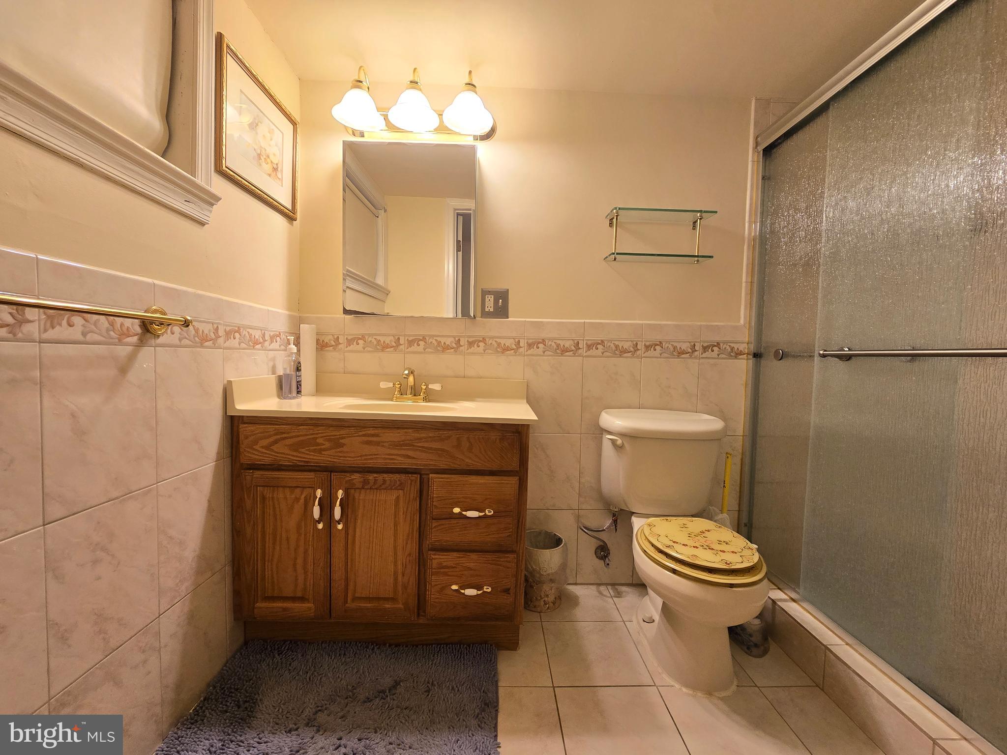414 Kerwin Road Silver Spring, MD 20901 - Photo 12 of 14 a bathroom with a sink a toilet and a mirror