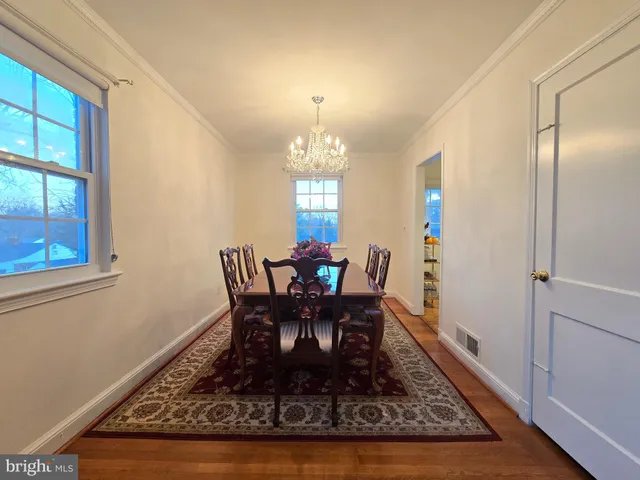 a dining room with furniture a rug and a chandelier