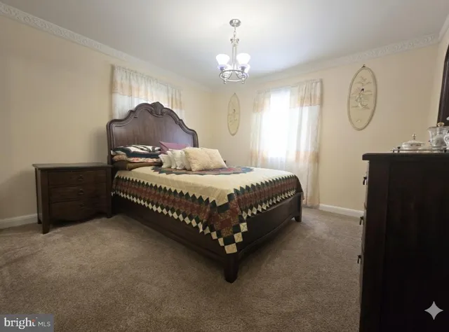 a bedroom with a bed dresser and a window