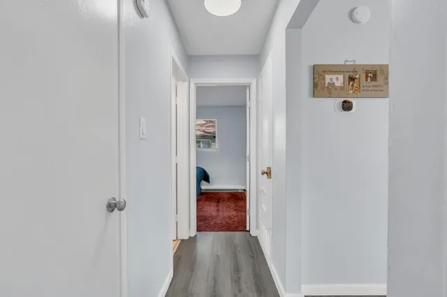 a view of a hallway with wooden floor