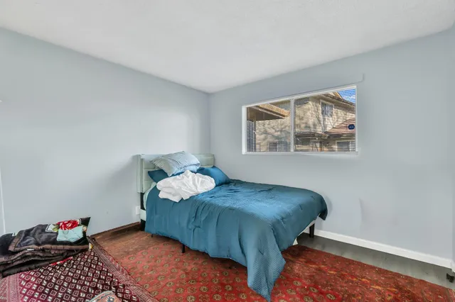 a bedroom with a bed and a window