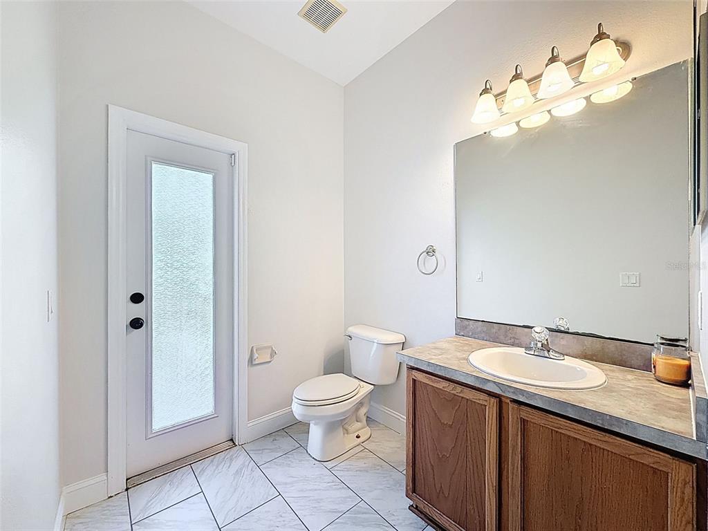 3311 Sisal Loop Wesley Chapel, FL 33544 - Photo 21 of 85 a spacious bathroom with a granite countertop sink a toilet and a mirror