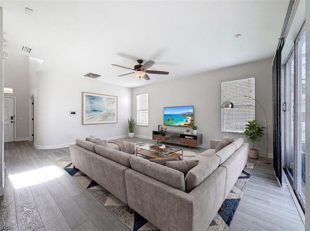 3311 Sisal Loop Wesley Chapel, FL 33544 - Photo 22 of 85 a living room with furniture and a wooden floor