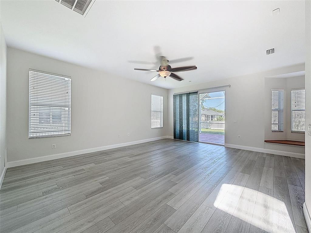 3311 Sisal Loop Wesley Chapel, FL 33544 - Photo 23 of 85 a view of an empty room with wooden floor and a window