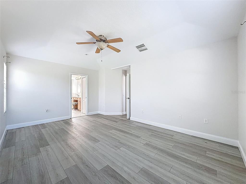 3311 Sisal Loop Wesley Chapel, FL 33544 - Photo 29 of 85 a view of empty room with wooden floor and fan