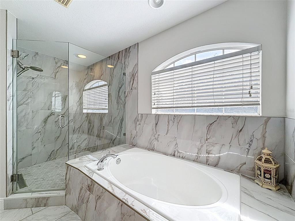 3311 Sisal Loop Wesley Chapel, FL 33544 - Photo 31 of 85 a bath tub sitting in a bathroom next to a window
