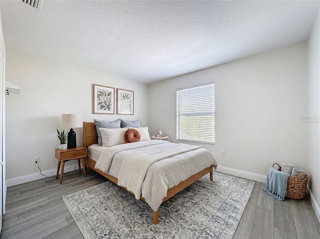 3311 Sisal Loop Wesley Chapel, FL 33544 - Photo 41 of 85 a bedroom with a bed and wooden floor