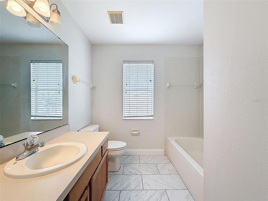 3311 Sisal Loop Wesley Chapel, FL 33544 - Photo 42 of 85 a bathroom with a sink a toilet and tub