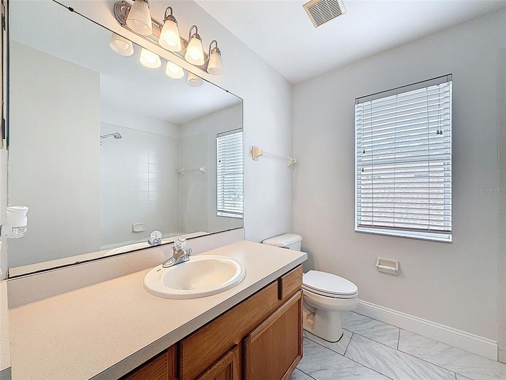 3311 Sisal Loop Wesley Chapel, FL 33544 - Photo 43 of 85 a bathroom with a sink a toilet and a mirror