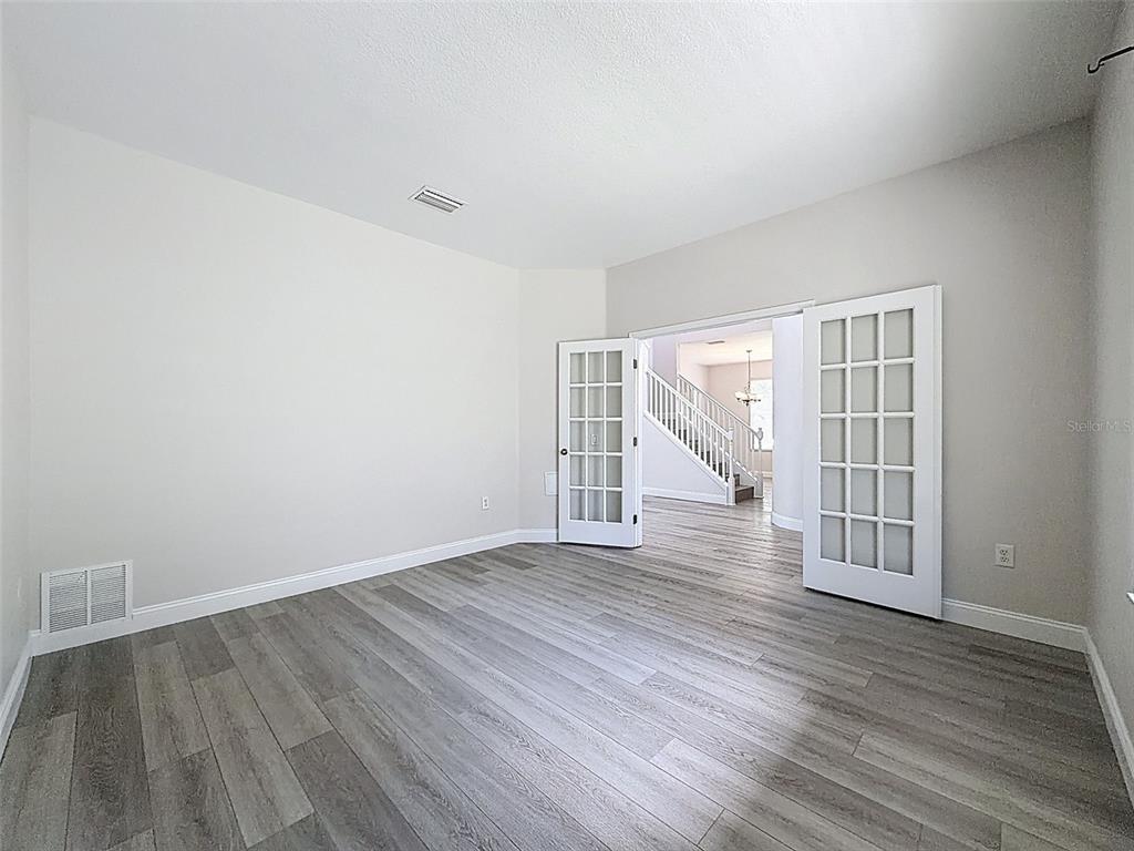 3311 Sisal Loop Wesley Chapel, FL 33544 - Photo 45 of 85 wooden floor in an empty room with a window