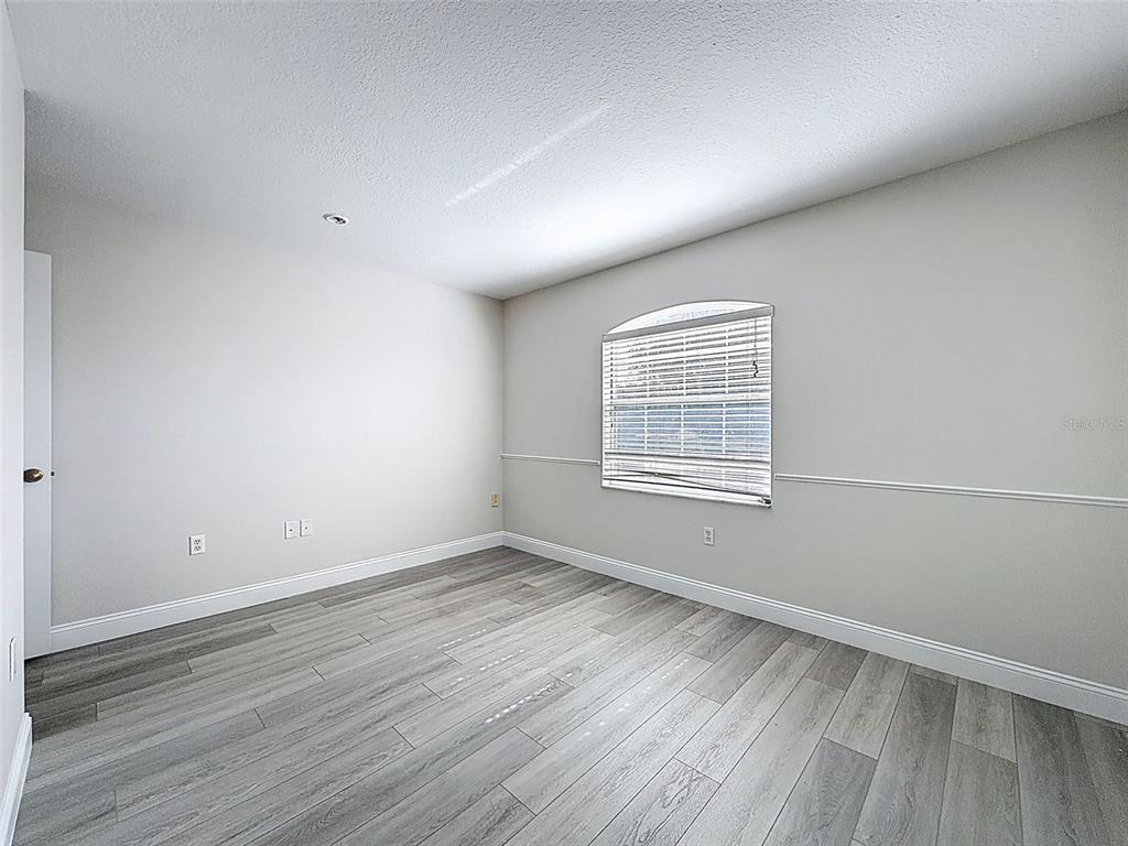 3311 Sisal Loop Wesley Chapel, FL 33544 - Photo 46 of 85 a view of an empty room with wooden floor and a window