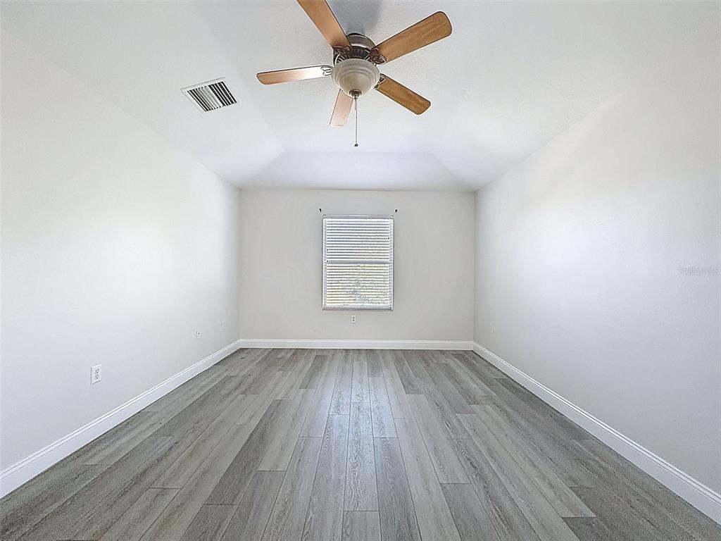 3311 Sisal Loop Wesley Chapel, FL 33544 - Photo 53 of 85 an empty room with a window and wooden floor
