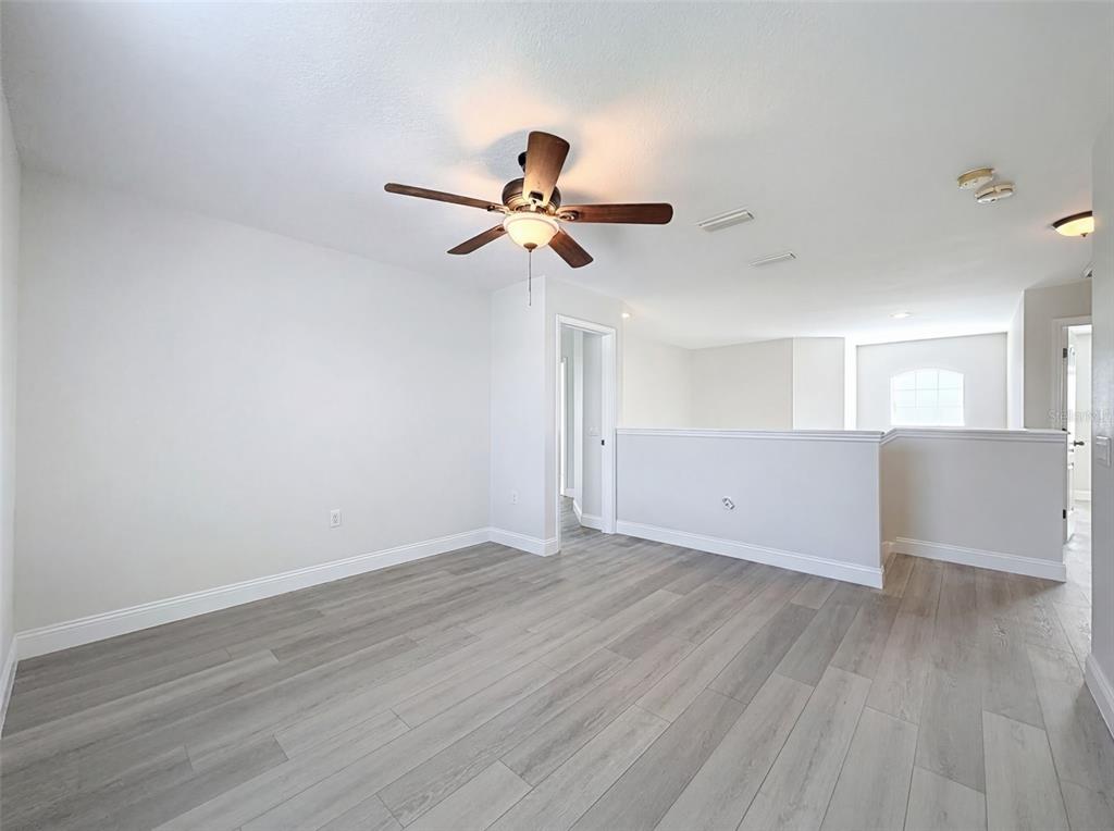 3311 Sisal Loop Wesley Chapel, FL 33544 - Photo 57 of 85 a view of an empty room and wooden floor