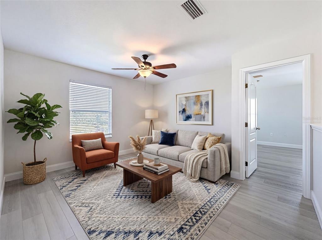 3311 Sisal Loop Wesley Chapel, FL 33544 - Photo 59 of 85 a living room with furniture potted plant and a lamp