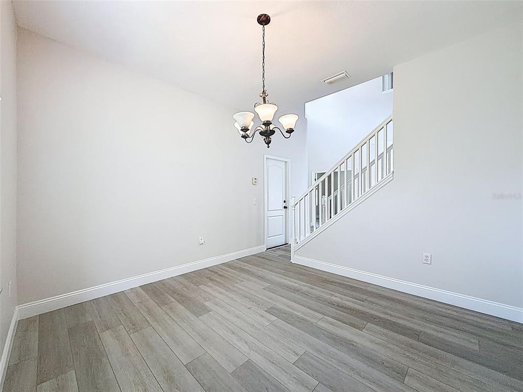 3311 Sisal Loop Wesley Chapel, FL 33544 - Photo 62 of 85 a view of a room with wooden floor and white walls