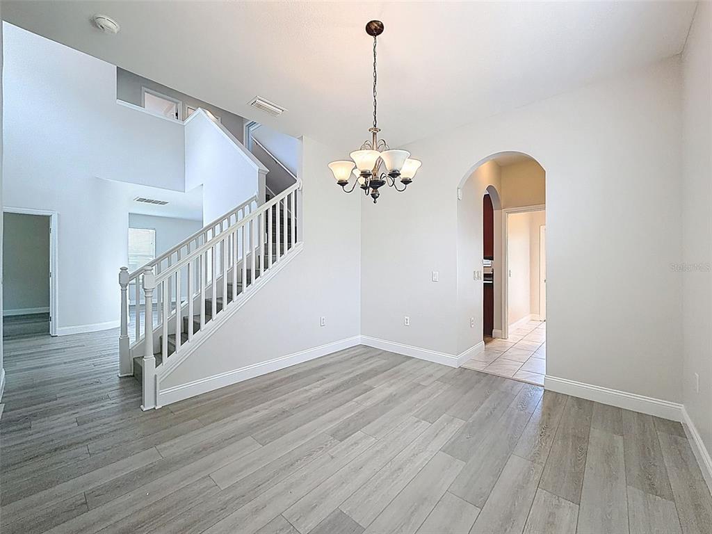 3311 Sisal Loop Wesley Chapel, FL 33544 - Photo 10 of 85 a view of a room with wooden floor chandelier and entryway