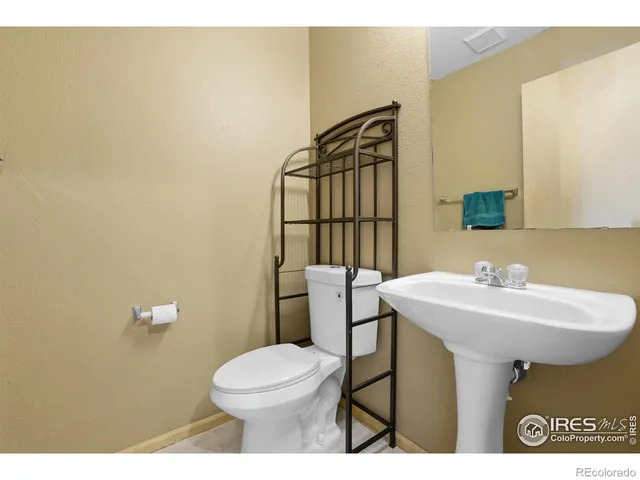 a bathroom with a sink a toilet and mirror