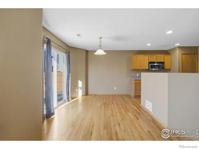 a view of a kitchen with a sink and a refrigerator
