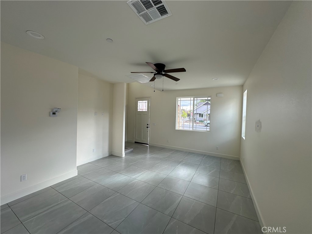 5215 Peony Court Riverside, CA 92506 - Photo 4 of 10 an empty room with a window and a ceiling fan