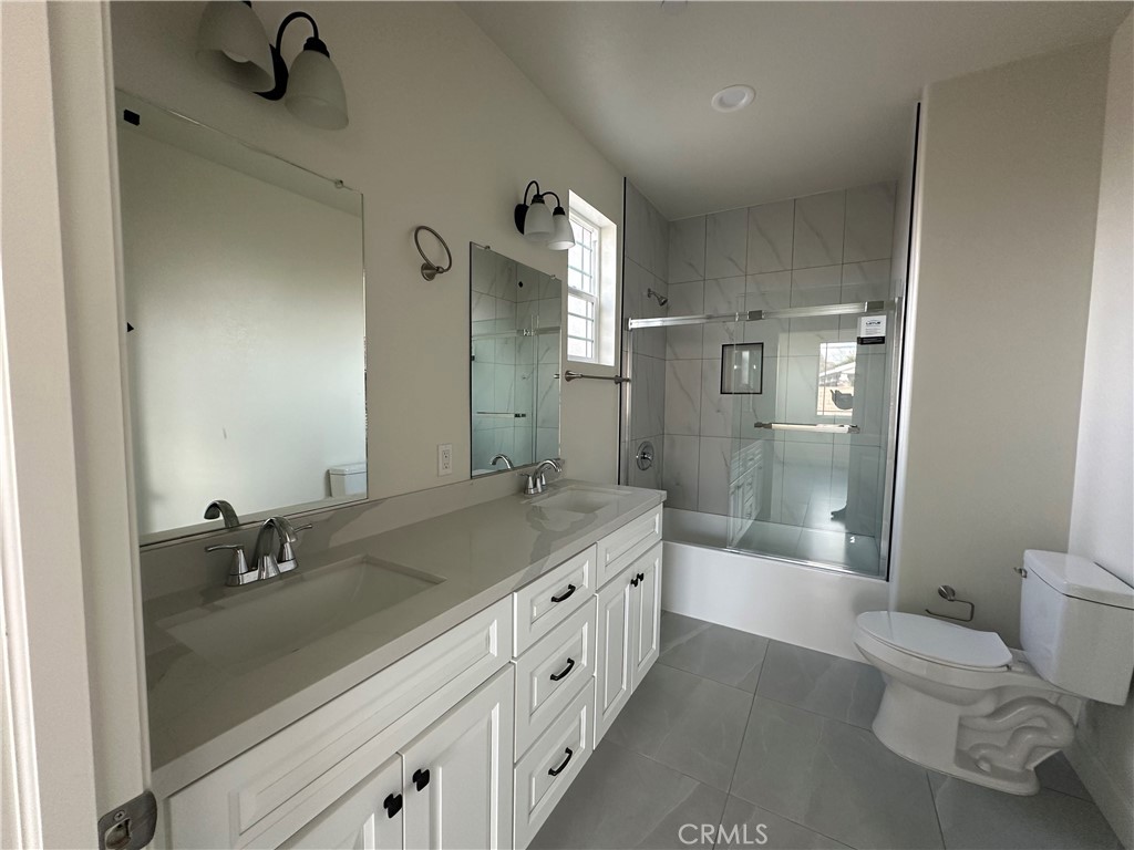 5215 Peony Court Riverside, CA 92506 - Photo 7 of 10 a spacious bathroom with a double vanity sink toilet mirror and bathtub