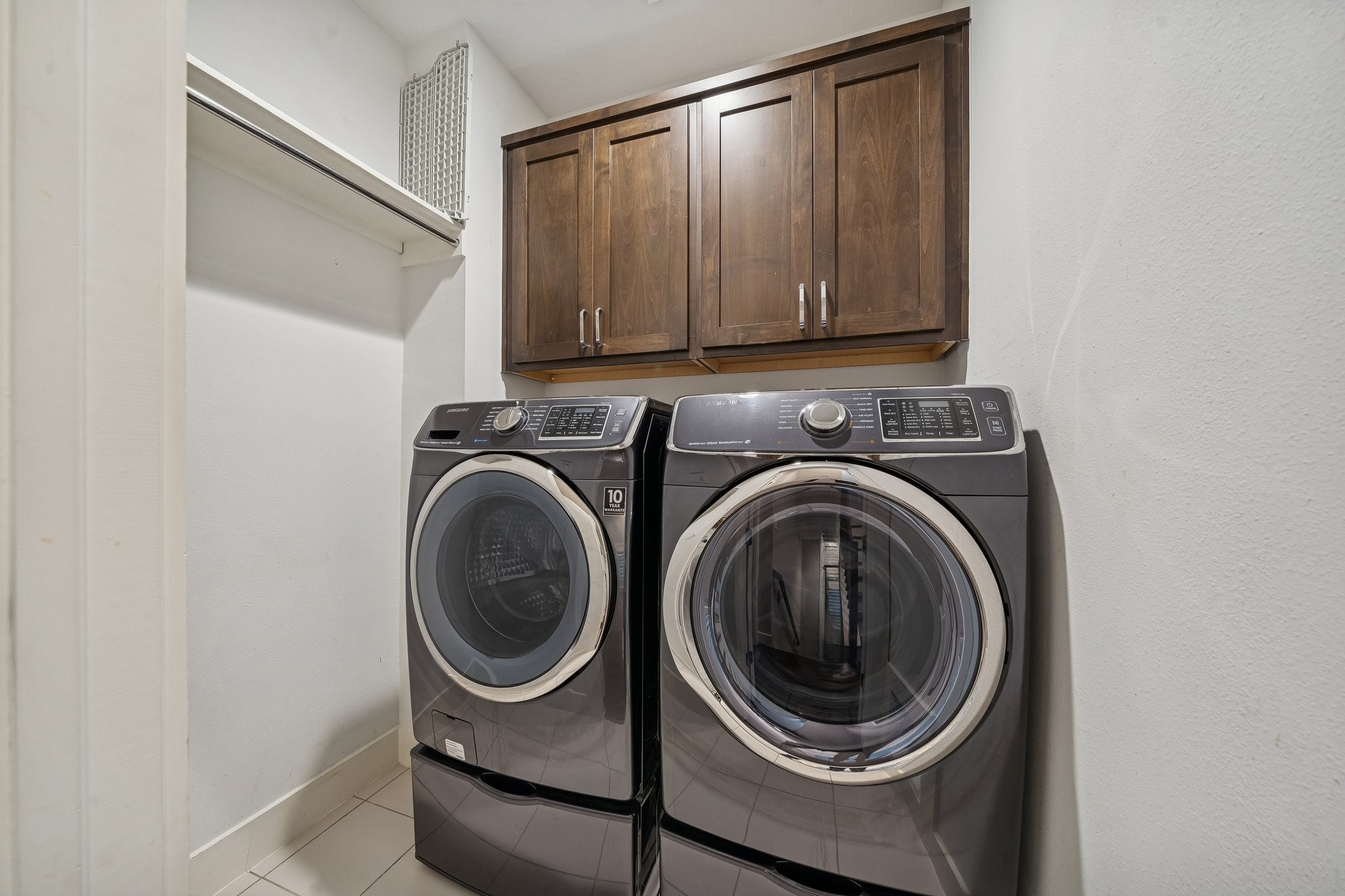 2105 Mason Street Houston, TX 77006 - Photo 19 of 43 Dedicated laundry space with built-in overhead cabinet for extra storage. Tiled flooring and open shelving make it easy to keep essentials organized and laundry days streamlined.