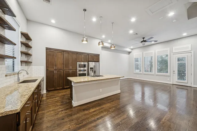 a view of living room with granite countertop furniture and wooden floor