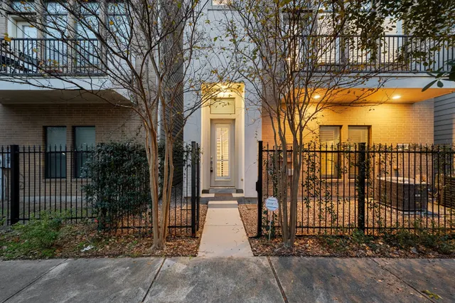a view of a brick building next to a yard
