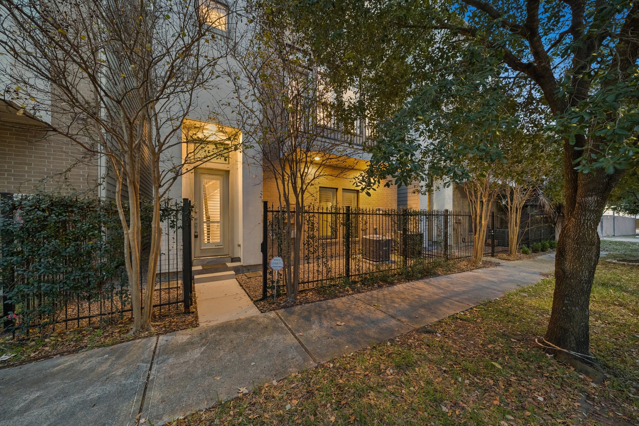2105 Mason Street Houston, TX 77006 - Photo 37 of 43 Stylish brick-and-stucco exterior with a private, fenced front entry that adds both curb appeal and everyday functionality. Elevated outdoor spaces and thoughtful window placement hint at the bright interiors and multi-level layout inside.