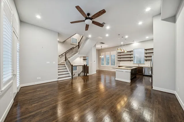 a kitchen that has a table and a wooden floors
