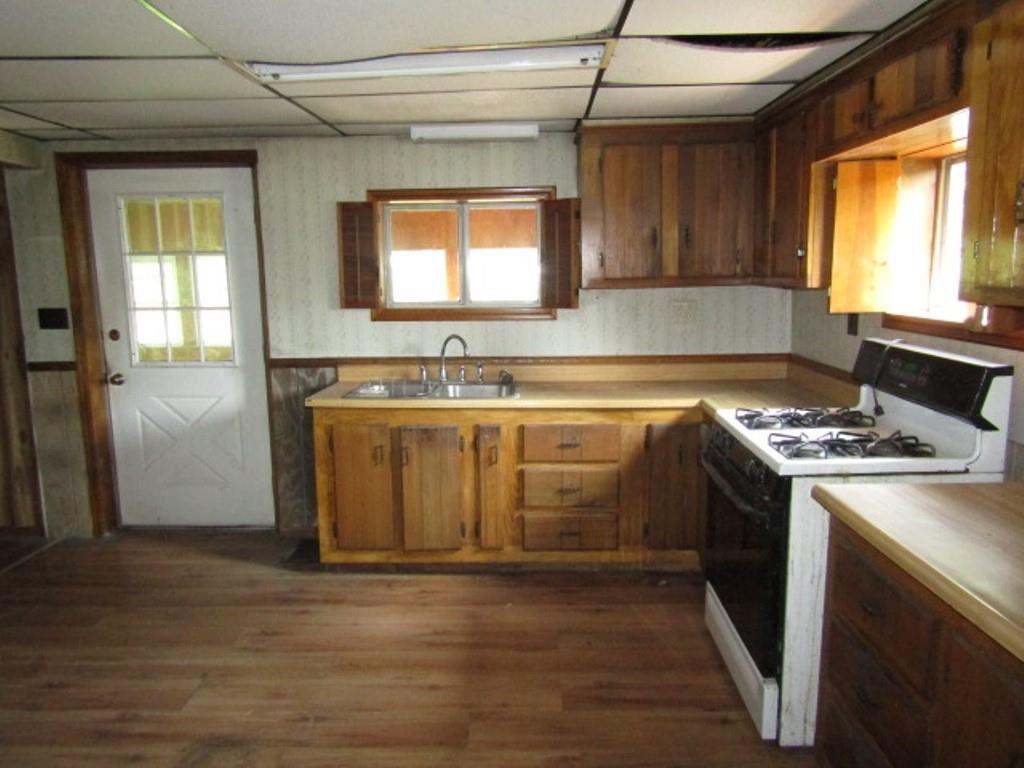 112 Wall Street Everson, PA 15631 - Photo 11 of 28 a kitchen with stainless steel appliances granite countertop a sink stove and refrigerator