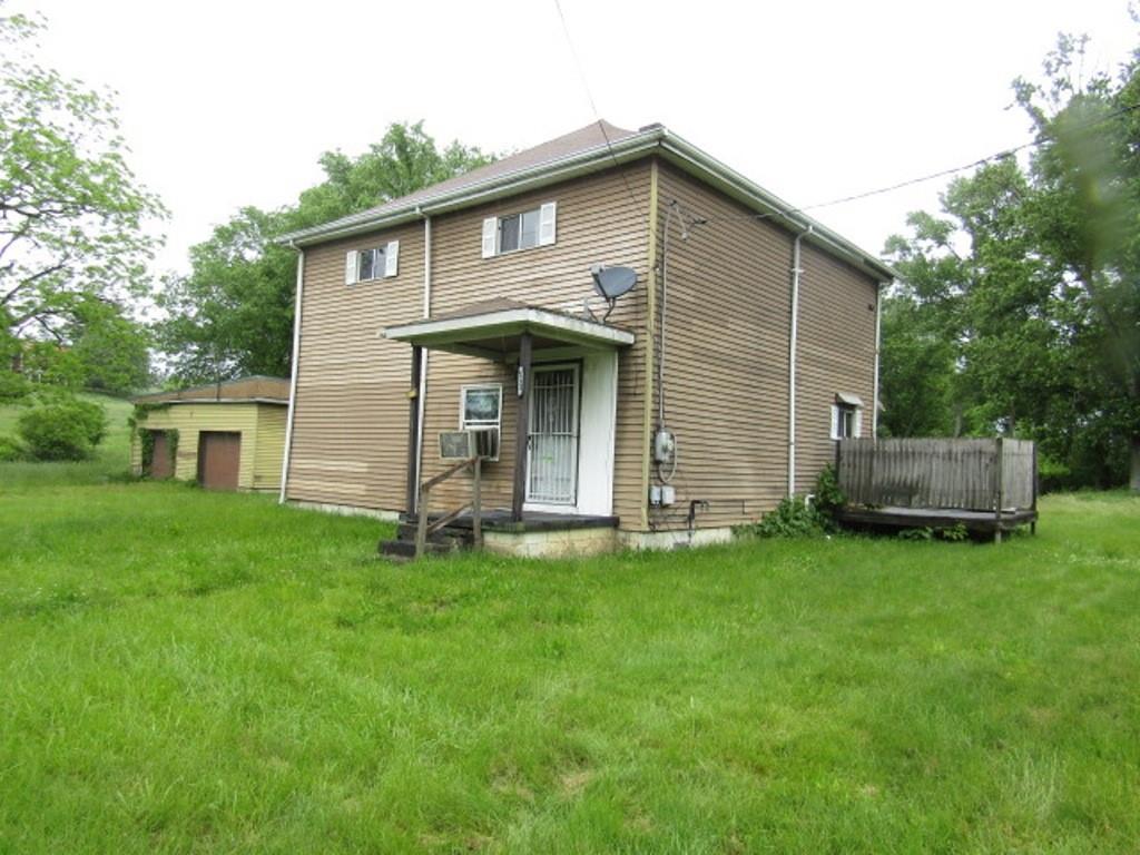 112 Wall Street Everson, PA 15631 - Photo 2 of 28 a front view of a house with a garden