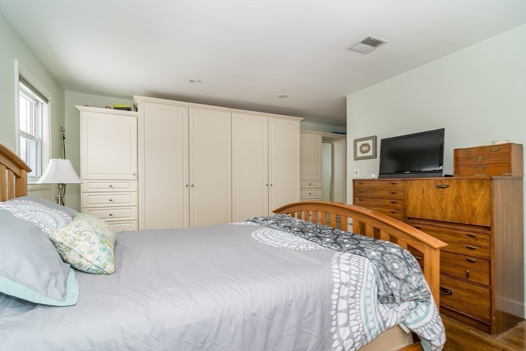 1 Cheryl Road Natick, MA 01760 - Photo 19 of 31 a bedroom with a bed and flat tv screen on the dresser