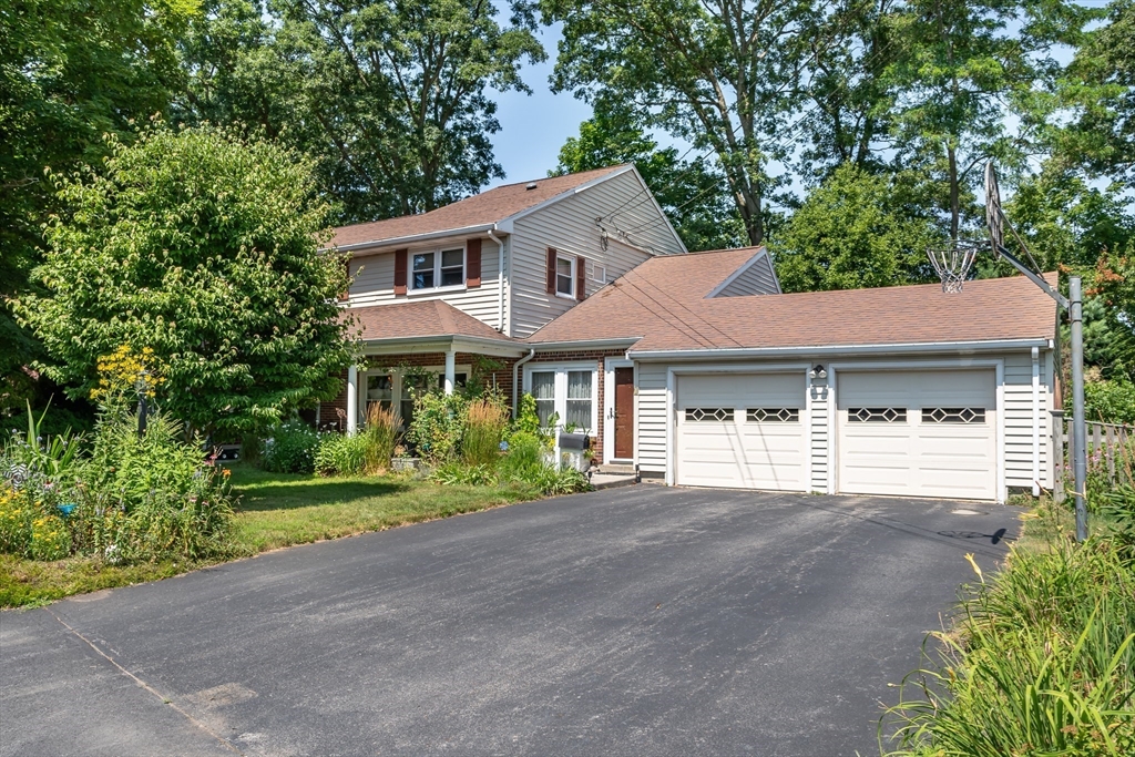 1 Cheryl Road Natick, MA 01760 - Photo 31 of 31 a front view of a house with a yard and garage