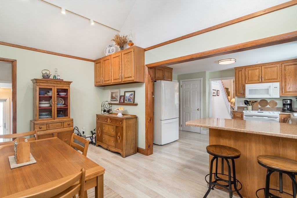 1 Cheryl Road Natick, MA 01760 - Photo 4 of 31 a kitchen with a table chairs refrigerator and cabinets