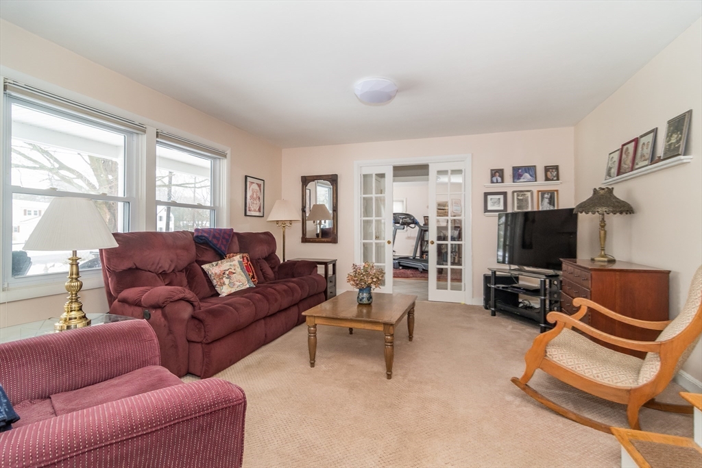 1 Cheryl Road Natick, MA 01760 - Photo 8 of 31 a living room with furniture a flat screen tv and a window